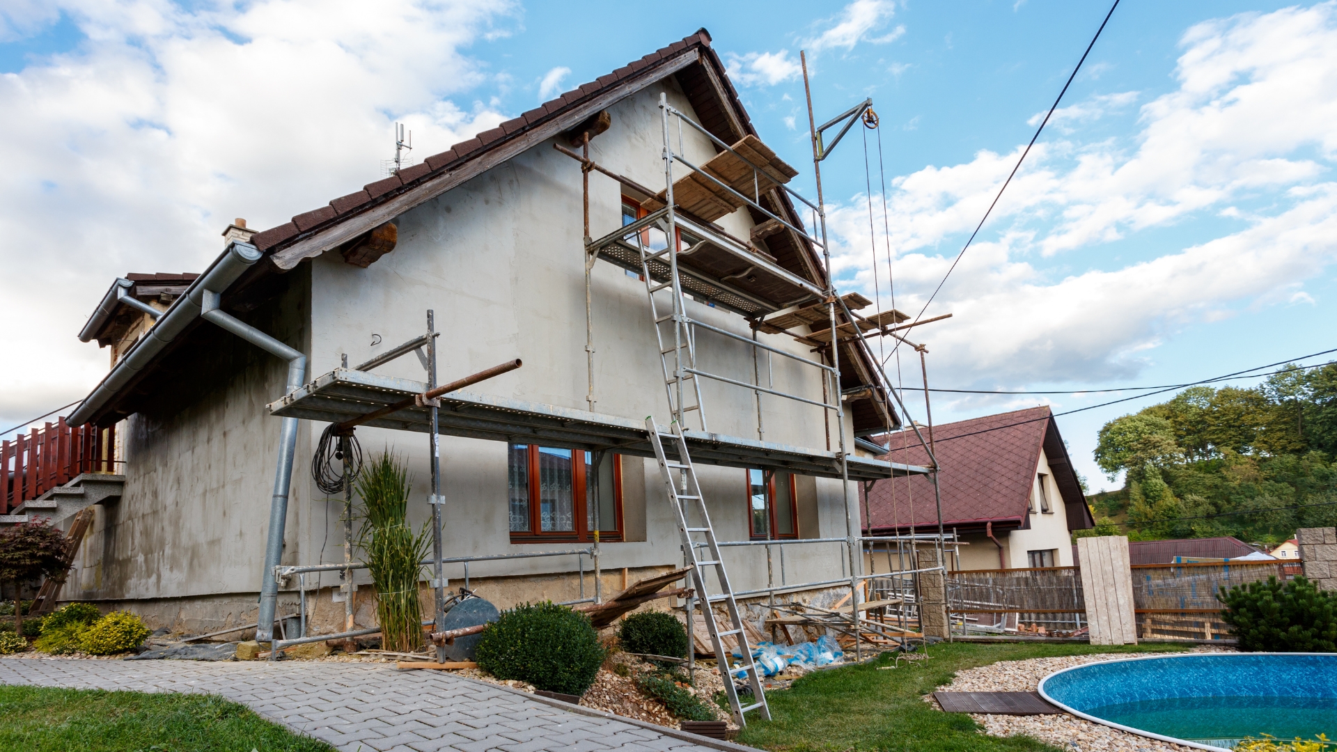 House undergoing full home remodeling with scaffolding set up for construction work
