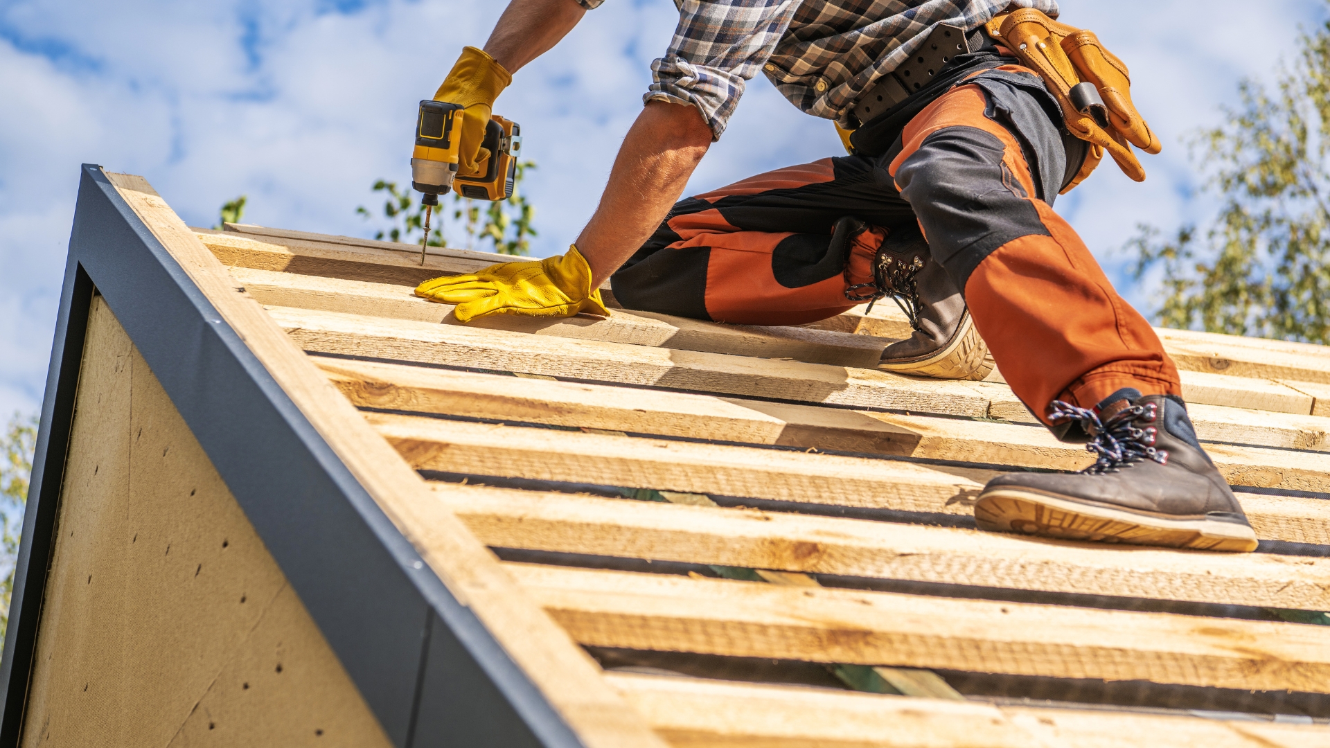 Roofing expert installing wooden framing for metal roofing on a residential home structure